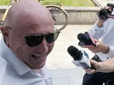 Mauro Lovisa sorridente davanti ai microfoni, dopo l’udienza