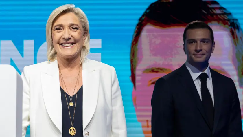 epa11400753 National Rally parliamentary party leader Marine Le Pen (L), standing next to leader Jordan Bardella (R), smiles after delivering a speech at the electoral party of the French right-wing party National Rally (Rassemblement National or RN) in Paris, France, 09 June 2024, after the first results of the European elections. The list of the Rassemblement National, led by party chief Jordan Bardella, is given winner in France according to first estimations after polls. EPA/ANDRE PAIN