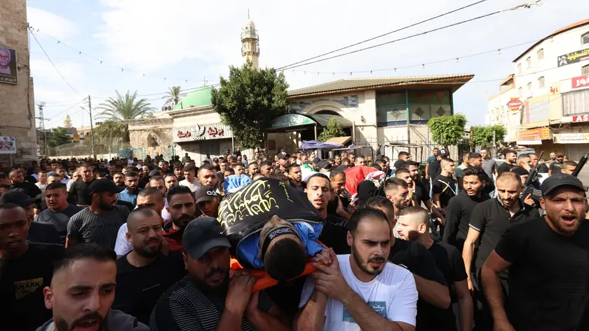 epa10948771 Mourners carry the body of one of four Palestinians killed during Israeli raids in the West Bank city of Jenin, 30 October 2023. According to the Palestinian Health Ministry, at least four Palestinians have been killed and five others injured during Israeli raids in Jenin. Israeli military spokesperson Daniel Hagari announced on 30 October, the Israeli Air Force (IAF) carried out an air strike operation in Jenin. EPA/ALAA BADARNEH