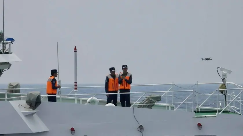 epa10903658 A handout picture made available by the Philippine Coast Guard (PCG) shows Chinese coastguard personnel on board a Chinese Coast Guard ship launching a drone in the disputed South China Sea on 04 October 2023 (issued on 06 October 2023). In a statement issued by Philippine Coast Guard (PCG) spokesperson for the West Philippine Sea Commodore, Jay Tarriela, on 06 October, the Philippine government strongly condemned the Chinese ship's dangerous maneuvers particularly the near collision with Philippine coast guard ship conducting a rotation and re-supply mission. China and the Philippines are engaged in a territorial dispute over the sovereignty of several islands and atolls in the South China Sea. EPA/Philippine Coast Guard / HANDOUT HANDOUT EDITORIAL USE ONLY/NO SALES