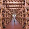 A worker checks in a special room where the Parma hams are hung to dry in Langhirano near Parma, October 13, 2009. Prosciutto di Parma can only be produced in a very restricted area of 29 sq km (11.2 sq mile) around the town of Parma in the region of Emilia Romagna, just north of Tuscany. Around 10 million hams are sold every year, of which about 2 million are exported, mainly to France, the United States and Germany, which each consume about 400,000 a year. To match Reuters Life! FOOD-ITALY/HAM REUTERS/Stefano Rellandini (ITALY FOOD SOCIETY IMAGES OF THE DAY)