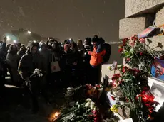 epa11159148 People lay flowers and light candles next to the photo of Russian late opposition leader Alexey Navalny during a vigil following his death, near the memorial to political prisoners in St. Petersburg, Russia, 16 February 2024. Russian opposition leader and outspoken Kremlin critic Alexey Navalny has died aged 47 in a penal colony, the Federal Penitentiary Service of the Yamalo-Nenets Autonomous District announced on 16 February 2024. A prison service statement said that Navalny 'felt unwell' after a walk on 16 February, and it was investigating the causes of his death. Late last year, he was transferred to an Arctic penal colony considered one of the harshest prisons. EPA/ANATOLY MALTSEV