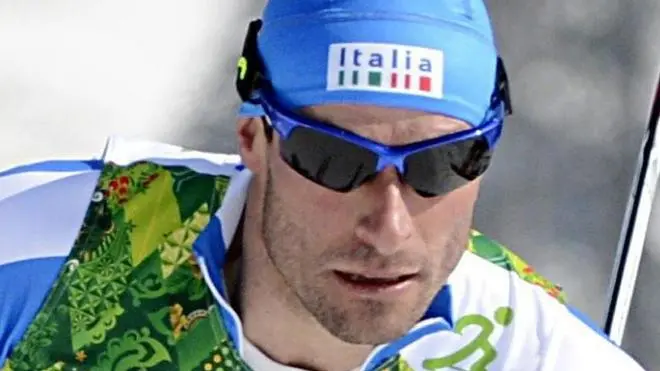 epa04081172 Giorgio Di Centa (R) of Italy ahead of Jonas Baumann of Switzerland in action during the Men's 4 X 10km Relay competition at the Laura Cross Country Center during the Sochi 2014 Olympic Games, Krasnaya Polyana, Russia, 16 February 2014. EPA/FILIP SINGER