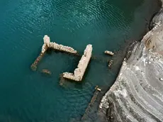 epaselect epa11576499 The remains of a building of the sunken village of Kallio is revealed due to the receding water level of Mornos artificial lake, near the village of Lidoriki in the prefecture of Fokida, about 240 km northwest of Athens, Greece, 29 August 2024 (issued 31 August 2024). Over the past two years, the level of Mornos artificial lake, which serves as a water supply to the capital Athens, has receded more than 35 meters, with approximately 18 just in the past year, according to local residents. In 1980 when the Mornos lake was completed by constructing a dam on the Mornos River, 80 houses along with their church and primary school of the village of Kallio, were evacuated and submerged in the water for the lake to be created. Nowadays, the few residents living around the lake observe with alarm every day how the buried village emerges, along with their childhood memories and everything they left behind. EPA/ALEXANDROS REMOUNDOS