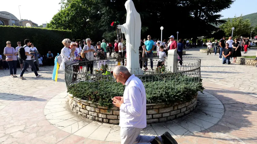 epa10710808 Pilgrims pray in front of the statue of Our Lady of Medjugorje, in the village of Medjugorje, Bosnia and Herzegovina, 25 June 2023. Pilgrims gathered in Medjugorje to mark the 42nd anniversary of the alleged appearance of the Virgin Mary to local shepherds in the hills surrounding the village on 24 June 1981. More than 30 million people are believed to have visited the world-famous village since the Virgin's first appearance, which the Catholic Church has not yet recognized. EPA/FEHIM DEMIR