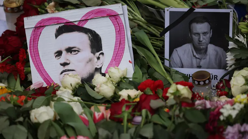 epa11163497 Portraits of deceased Alexei Navalny are positioned between flowers during a rally in reaction to the death of Russian opposition leader Alexei Navalny in front of the Russian embassy, in Berlin, Germany, 18 February 2024. Russian opposition leader and outspoken Kremlin critic Alexei Navalny has died aged 47 in a penal colony, the Federal Penitentiary Service of the Yamalo-Nenets Autonomous District announced on 16 February 2024. A prison service statement said that Navalny 'felt unwell' after a walk on 16 February, and it was investigating the causes of his death. In late 2023 Navalny was transferred to an Arctic penal colony considered one of the harshest prisons. EPA/CLEMENS BILAN