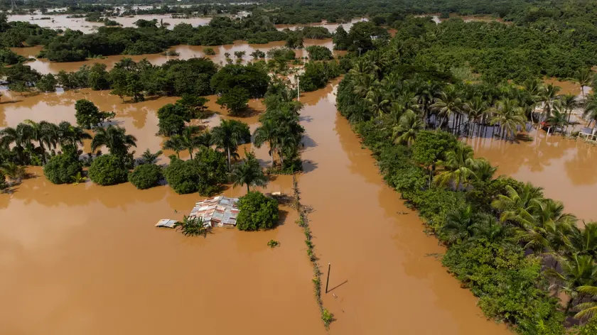 epa10986590 Aerial view of the fields and the Santo Domingo Ring Road, affected by the intense rains in Aguacate, Dominican Republic, 20 November 2023. The Dominican authorities raised the official number of deaths to 24 as a result of the torrential rains that affected that country over the weekend and that have also left thousands of people displaced, damage to homes and infrastructure, as well as power and water outages. EPA/Orlando Barria