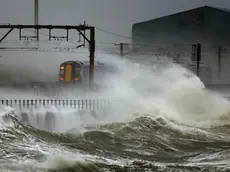 epa04006815 A train passes along the coast at Saltcoats in Scotland which is battered by big sea waves 3 January 2014 as Britain is braced for the worst as a combination of high tides, heavy rains and strong winds are expected to bring yet more severe flooding to parts of the country. EPA/Danny Lawson UK and Republic of Ireland Out EDITORIAL USE ONLY EDITORIAL USE ONLY