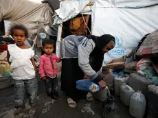 epa10541342 Yemeni children stand next to their grandmother at a makeshift camp for Internally Displaced Persons (IDPs) in Sana'a, Yemen, 23 March 2023 (issued 24 March 2023). More than 11 million children in Yemen require urgent humanitarian aid as they could face greater risks of malnutrition due to the consequences of eight years of the endless and crushing war in the Arab country, the United Nations Children's Agency (UNICEF) has warned. The protracted war in Yemen is referred to as the Saudi Arabia-Iran proxy conflict in which the warring parties have been militarily and politically backed by Saudi Arabia and Iran respectively since 2015. EPA/YAHYA ARHAB