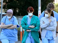 People and health workers wear protective face masks outside the hospital in Padua, Veneto region, northern Italy, 22 February 2020. A second person in Italy has died after being infected with the coronavirus. The death of a woman in the northern region of Lombardy follows that of a 78-year-old man who died on Friday. The new wave of cases in Italy's northern regions have triggered shut-downs of shops, offices and community centres. ANSA/NICOLA FOSSELLA