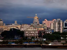 epa11239724 Dark clouds avbove the skyline of downtown during a rainy day in Havana, Cuba, 23 March 2024. Intense rains that have affected the western region of Cuba since 22 March have left 270,000 residents without electricity service, 26 total landslides in Havana alone and some 762 people self-evacuated in relatives' homes, the authorities of the Caribbean country reported. EPA/Ernesto Mastrascusa