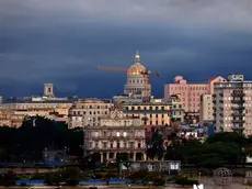 epa11239724 Dark clouds avbove the skyline of downtown during a rainy day in Havana, Cuba, 23 March 2024. Intense rains that have affected the western region of Cuba since 22 March have left 270,000 residents without electricity service, 26 total landslides in Havana alone and some 762 people self-evacuated in relatives' homes, the authorities of the Caribbean country reported. EPA/Ernesto Mastrascusa