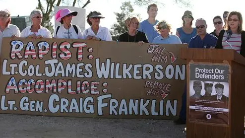 Shelli Hanks, far right, sister-in-law of Kimberly Hanks, speaks during a protest outside of Davis-Monthan Air Force Base in Tucson, Ariz. on Thursday, April 25, 2013. The protesters rallied to denounce the Air Force's decision to transfer Lt. Col. James Wilkerson to Arizona after his sexual assault conviction was overturned by a commander, adding to the growing criticism of the military justice system. Kimberly Hanks, a civilian employee who works with service members, accused Wilkerson of sexually assaulting her after a March 2012 party at his house. (AP Photo/Arizona Daily Star, Mamta Popat) ALL LOCAL TV OUT; PAC-12 OUT; MANDATORY CREDIT