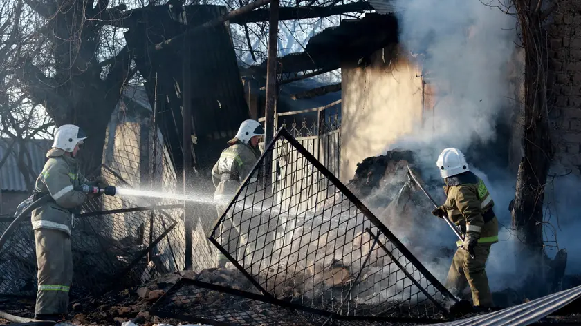 epaselect epa08203375 Firefighters douse the remaining fire in burnt houses and property in the village of Blas - Batyr, after ethnic clashes between Kazakhs and Dungans 250km from Almaty, Kazakhstan, 08 February 2020. Eight people were killed and forty-eight people were injured in the clashes. EPA/IGOR KOVALENKO