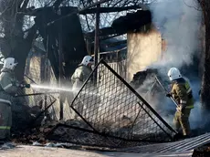 epaselect epa08203375 Firefighters douse the remaining fire in burnt houses and property in the village of Blas - Batyr, after ethnic clashes between Kazakhs and Dungans 250km from Almaty, Kazakhstan, 08 February 2020. Eight people were killed and forty-eight people were injured in the clashes. EPA/IGOR KOVALENKO