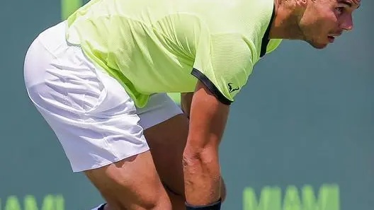 epa05881587 Rafael Nadal of Spain loses his right tennis shoe in action against Fabio Fognini of Italy during a semifinal round match at the Miami Open tennis tournament on Key Biscayne, Miami, Florida, USA, 31 March 2017. EPA/ERIK S. LESSER