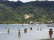 epa04538638 A photo made available on 23 December 2014 shows foreign tourists enjoy on the 2004 tsunami hit Patong beach, Phuket island, southern Thailand, 30 November 2014. Ceremonies across Phuket and Phang Nga are held to mark the ten year anniversary of the Boxing Day tsunami which struck 26 December 2004. More than 5,000 people were killed in Thailand, many of them foreigners vacationing in the area, among more than 280,000 who were killed or are missing as the devastating waves struck 14 nations on the Indian Ocean. EPA/YONGYOT PRUKSARAK
