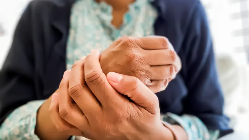 mid adult woman feels the dry skin on her hands