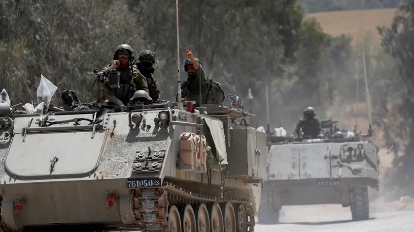 epa11297687 Israeli soldiers ride in their APCs on their way to enter the Gaza Strip at an undisclosed location near the Israeli Israeli border with the Gaza Strip, 24 April 2024. More than 34,000 Palestinians and over 1,450 Israelis have been killed, according to the Palestinian Health Ministry and the Israel Defense Forces (IDF), since Hamas militants launched an attack against Israel from the Gaza Strip on 07 October 2023, and the Israeli operations in Gaza and the West Bank which followed it. EPA/ATEF SAFADI