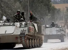 epa11297687 Israeli soldiers ride in their APCs on their way to enter the Gaza Strip at an undisclosed location near the Israeli Israeli border with the Gaza Strip, 24 April 2024. More than 34,000 Palestinians and over 1,450 Israelis have been killed, according to the Palestinian Health Ministry and the Israel Defense Forces (IDF), since Hamas militants launched an attack against Israel from the Gaza Strip on 07 October 2023, and the Israeli operations in Gaza and the West Bank which followed it. EPA/ATEF SAFADI