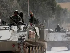 epa11297687 Israeli soldiers ride in their APCs on their way to enter the Gaza Strip at an undisclosed location near the Israeli Israeli border with the Gaza Strip, 24 April 2024. More than 34,000 Palestinians and over 1,450 Israelis have been killed, according to the Palestinian Health Ministry and the Israel Defense Forces (IDF), since Hamas militants launched an attack against Israel from the Gaza Strip on 07 October 2023, and the Israeli operations in Gaza and the West Bank which followed it. EPA/ATEF SAFADI