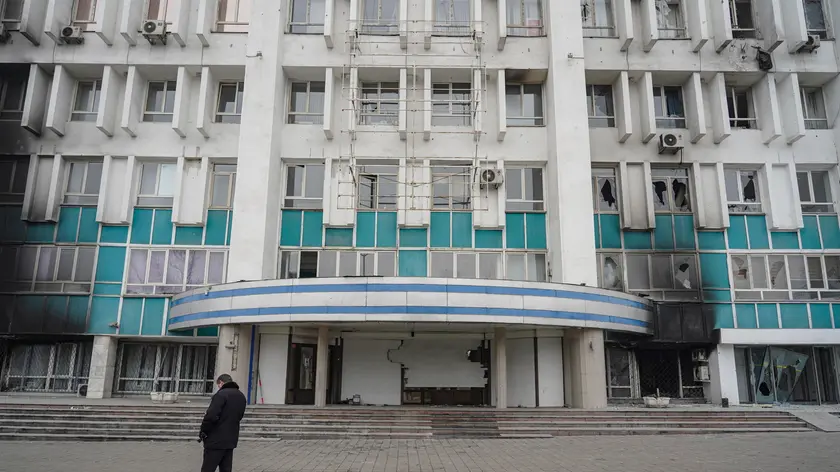 epa09678686 A Kazakh man stands in front of burnt and looted building housing the main TV companies in the aftermath of riots in downtown of Almaty, Kazakhstan, 11 January 2022. Mass protests in Kazakhstan began in the early days of 2022 - residents of the cities of Zhanaozen and Aktau in the west of the country opposed a twofold increase in prices for liquefied gas. Later, the protests turned into looting, the militants attacked state institutions, took away weapons. The authorities declared a state of emergency across the country until 19 January and launched a counter-terrorism operation. As reported by the Ministry of Health of Kazakhstan, some 164 people where killed during the riots. As a result of the riots, 2,265 people in different regions of the country applied for medical assistance while 83 people remain in serious condition in hospitals of Kazakhstan. EPA/STR