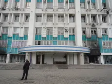 epa09678686 A Kazakh man stands in front of burnt and looted building housing the main TV companies in the aftermath of riots in downtown of Almaty, Kazakhstan, 11 January 2022. Mass protests in Kazakhstan began in the early days of 2022 - residents of the cities of Zhanaozen and Aktau in the west of the country opposed a twofold increase in prices for liquefied gas. Later, the protests turned into looting, the militants attacked state institutions, took away weapons. The authorities declared a state of emergency across the country until 19 January and launched a counter-terrorism operation. As reported by the Ministry of Health of Kazakhstan, some 164 people where killed during the riots. As a result of the riots, 2,265 people in different regions of the country applied for medical assistance while 83 people remain in serious condition in hospitals of Kazakhstan. EPA/STR
