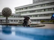 epa11347827 People carrying an umbrella walk outside the F. D. Roosevelt University Hospital, where Slovak Prime Minister Robert Fico is being treated after being shot two days earlier, in Banska Bystrica, Slovakia, 17 May 2024. The Slovak government office on 15 May confirmed there had been an assassination attempt on Prime Minister Robert Fico following a meeting in the town of Handlova. According to the director of the hospital Miriam Lapunikova, Fico is conscious and stable at the time, but he is still placed in the Anesthesiology and Resuscitation unit. She said that his condition is 'truly very serious'. EPA/MARTIN DIVISEK EPA-EFE/MARTIN DIVISEK