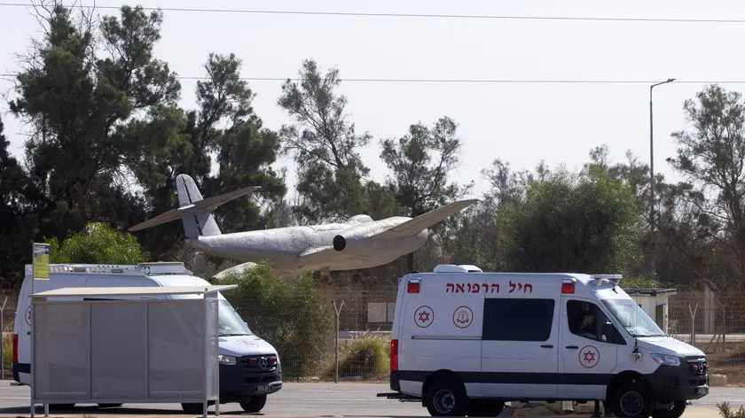 epa10992447 Ambulances enter Hatzerim Airbase during the preparations to receive the Israeli hostages held by Hamas after their release, in Hatzerim, Southern Israel, 24 November 2023. Israel and Hamas agreed to a 4-day ceasefire agreement, mediated by Qatar, the US, and Egypt, that came into effect at 05:00 AM GMT on 24 November, with 50 Israeli hostages, women and children, to be released by Hamas. And 150 Palestinian women and children that were detained in Israeli prisons to be released in exchange. More than 14.000 Palestinians and at least 1,200 Israelis have been killed, according to the Gaza Government media office and the Israel Defense Forces (IDF), since Hamas militants launched an attack against Israel from the Gaza Strip on 07 October, and the Israeli operations in Gaza and the West Bank which followed it. EPA/CHRISTOPHE PETIT TESSON