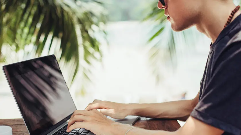 Caucasian man using laptop outdoors