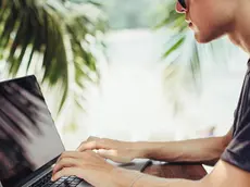 Caucasian man using laptop outdoors