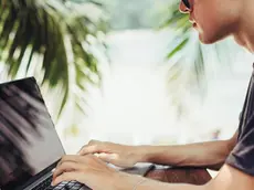 Caucasian man using laptop outdoors