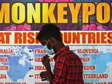 epa10334196 (FILE) - An Indian health worker walks in front of a list of high-risk countries for the Monkeypox virus, at Chennai International Airport, in Chennai, India, 16 July 2022 (reissued 28 November 2022). The World Health Organization (WHO) in a statement on 28 November 2022 said it "will begin using a new preferred term mpox as a synonym for monkeypox" simultaneously for one year until the term 'monkeypox' is phased out. The decsion was taken after consultations with global experts as "racist and stigmatizing language online, in other settings and in some communities was observed and reported to WHO." EPA/IDREES MOHAMMED