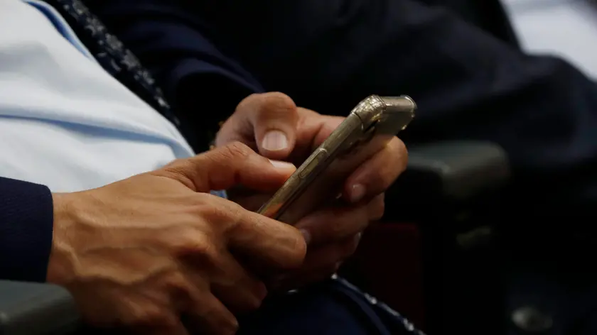 epa10633435 A Yemeni makes SMS with a smartphone on the World Telecommunication and Information Society Day, in Sana'a, Yemen, 17 May 2023. The World Telecommunication and Information Society Day (WTISD) is an annual observance that is celebrated on 17 May to raise awareness about the importance of telecommunications and the role of information and communication technologies (ICTs) in promoting social and economic development worldwide. EPA/YAHYA ARHAB