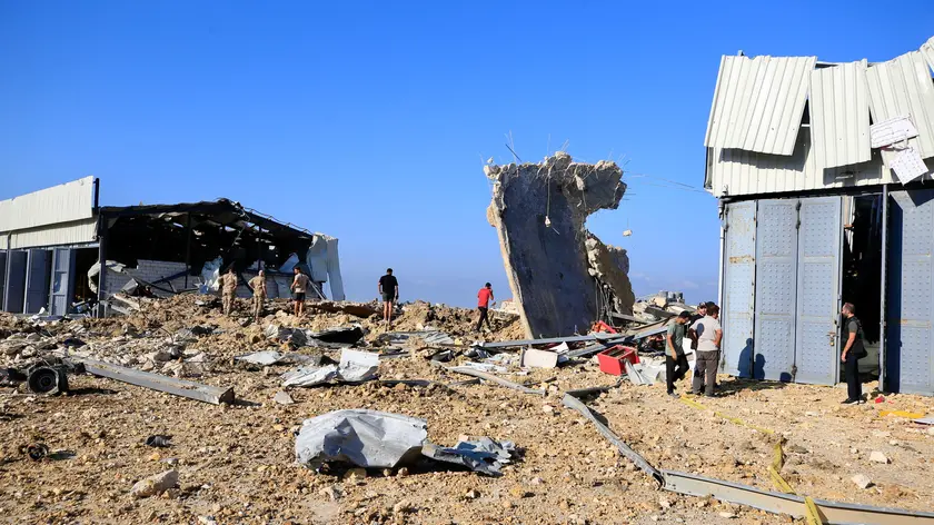 epa11623385 People inspect the area near by a damaged building after Israeli raids in Jiyeh, South Lebanon on 25 September2024. According to Lebanon's Ministry of Health, at least 558 people have been killed, and more than 1,835 have been injured following continued Israeli airstrikes on southern Lebanese towns and villages. More than 41,300 Palestinians and over 1,400 Israelis have been killed, according to the Palestinian Health Ministry and the Israel Defense Forces (IDF), since Hamas militants launched an attack against Israel from the Gaza Strip on 07 October 2023, and the Israeli operations in Gaza and the West Bank which followed it. EPA/STR