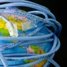 Network cable wrapped around a globe depicting a connected world