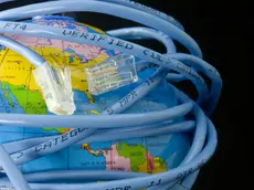 Network cable wrapped around a globe depicting a connected world