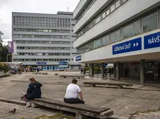 epa11346980 People sit outside the F. D. Roosevelt University Hospital, where Slovak Prime Minister Robert Fico is being treated after being shot two days earlier, in Banska Bystrica, Slovakia, 17 May 2024. The Slovak government office on 15 May confirmed there had been an assassination attempt on Prime Minister Robert Fico following a meeting in the town of Handlova. Slovak President-elect Peter Pellegrini, who visited Fico in hospital and spoke with him, told journalists that Fico's condition remains very serious. EPA/MARTIN DIVISEK