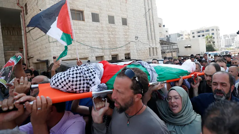 epa11594514 People carry the body of late Turkish-American activist Aysenur Ezgi Eygi during her funeral procession in the West Bank city of Nablus, 09 September 2024. According to the Palestinian news agency WAFA, the 26-year-old activist succumbed to her wounds after being shot in the head by Israeli forces during a protest against settlement expansion in Beita, near Nablus, on 06 September. She was taken to hospital, where she was pronounced dead, WAFA added. EPA/ALAA BADARNEH