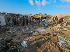 epa11586189 Internally displaced Palestinians inspect destroyed shelters following an Israeli military strike near Al-Aqsa Martyrs Hospital in Deir Al Balah, central Gaza Strip, 05 September 2024. According to the Palestinian Ministry of Health in Gaza, more than four Palestinians were killed after an Israeli air strike hit near the hospital. The Israeli military stated that it conducted a 'targeted' airstrike overnight on a 'Command and Control Center' used by Hamas and Islamic Jihad, which was embedded in the humanitarian area in Deir Al Balah, to 'remove an immediate threat', adding that prior to the strike 'numerous steps' were taken to mitigate the risk of harming civilians. More than 40,000 Palestinians and over 1,400 Israelis have been killed, according to the Palestinian Health Ministry and the Israel Defense Forces (IDF), since Hamas militants launched an attack against Israel from the Gaza Strip on 07 October 2023, and the Israeli operations in Gaza and the West Bank which followed it. EPA/MOHAMMED SABER