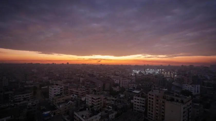 epa10923075 Al Shifa hospital is lit up during sunrise in Gaza City, 17 October 2023. Israel has warned all citizens of the Gaza strip to move to the south ahead of an expected invasion. More than 2,750 Palestinians and 1,300 Israelis have been killed according to the IDF and Palestinian health ministry, after Hamas militants launched an attack against Israel from the Gaza Strip on 07 October. EPA/MOHAMMED SABER