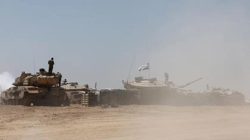 epa11328514 Israeli soldiers with military vehicles gather at an undisclosed position near the border fence with the Gaza Strip, in southern Israel, 09 May 2024. US Defense Secretary Austin at a Senate Appropriations Committee meeting on 08 May confirmed the Biden administration's decision to pause a shipment of 'high payload munitions' to Israel amid concerns over an Israeli major offensive in the southern Gaza city of Rafah. The Israeli military on 06 May called on residents of eastern Rafah to 'temporarily' evacuate to an expanded humanitarian area. On 07 May, Israel said that its troops began an operation targeting Hamas militants and infrastructure within specific areas of eastern Rafah, taking operational control of the Gazan side of the Rafah crossing. More than 34,800 Palestinians and over 1,455 Israelis have been killed, according to the Palestinian Health Ministry and the Israel Defense Forces (IDF), since Hamas militants launched an attack against Israel from the Gaza Strip on 07 October 2023, and the Israeli operations in Gaza and the West Bank which followed it. EPA/ABIR SULTAN