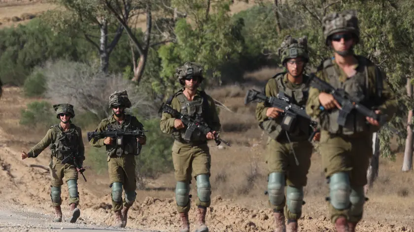 epaselect epa11408270 Israeli soldiers patrol along the border with the Gaza Strip, at an undisclosed location in southern Israel, 13 June 2024. The Israeli military stated on 13 June that its troops are continuing to operate against 'terrorist infrastructure and operatives' in the Gaza Strip. More than 37,000 Palestinians and over 1,400 Israelis have been killed, according to the Palestinian Health Ministry and the Israel Defense Forces (IDF), since Hamas militants launched an attack against Israel from the Gaza Strip on 07 October 2023, and the Israeli operations in Gaza and the West Bank which followed it. EPA/ABIR SULTAN