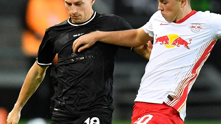 Moenchengladbach's Stefan Lainer, left, and Leipzig's Lazar Samardzic challenge for the ball during the German Bundesliga soccer match between Borussia Moenchengladbach and RB Leipzig in Moenchengladbach, Germany, Saturday, Oct. 31, 2020. (AP Photo/Martin Meissner, Pool)