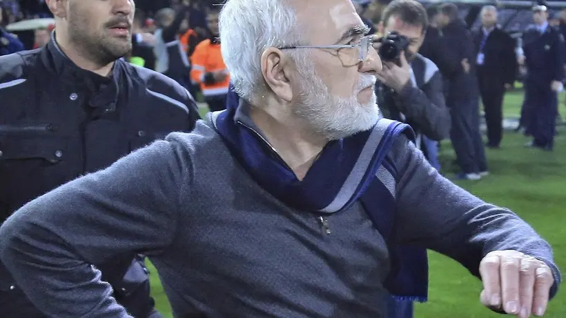 PAOK owner, businessman Ivan Savvidis invades into the pitch during a Greek League soccer match between PAOK and AEK Athens in the northern Greek city of Thessaloniki, Sunday, March 11, 2018. Savvidis came on the field twice and was accompanied by bodyguards. On the second occasion, without the overcoat he was wearing before, Savvidis appeared to be carrying a pistol which was in its holder. Savvidis made no move to use the weapon at any time. (InTime Sports via AP)