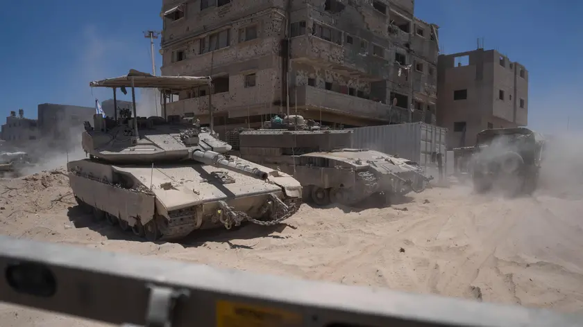 epa11464375 Image taken 03 July 2024 and released 07 July 2024 showing Israeli tanks next to destroyed buildings during a ground operation in the southern Gaza Strip. The Israeli military invited reporters for a tour of Rafah, where the military has been operating since May 6. EPA/Ohad Zwigenberg / POOL