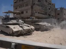 epa11464375 Image taken 03 July 2024 and released 07 July 2024 showing Israeli tanks next to destroyed buildings during a ground operation in the southern Gaza Strip. The Israeli military invited reporters for a tour of Rafah, where the military has been operating since May 6. EPA/Ohad Zwigenberg / POOL