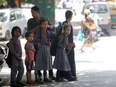 epa11311842 School children escorted by their parents in New Delhi, India, 01 May 2024. About a hundred schools in Delhi and the national capital region received bomb threats early on May 01, prompting evacuations. The national capital's lieutenant governor, VK Saxena, said police had traced the origin of the hoax bomb emails sent to nearly 100 schools. EPA/HARISH TYAGI
