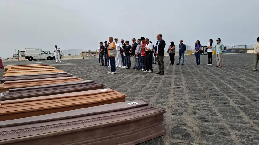 The 10 coffins of migrants found dead in the hatch of the hold of the boat on which they were travelling, landed on the pier of Porto Empedocle, Italy, 19 June 2024, after their departure from Libya. The vessel with 54 survivors on board was rescued by the NGO Nadir which towed it to Lampedusa. ANSA/Concetta Rizzo