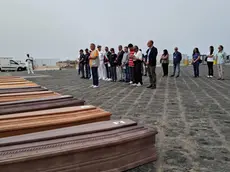 The 10 coffins of migrants found dead in the hatch of the hold of the boat on which they were travelling, landed on the pier of Porto Empedocle, Italy, 19 June 2024, after their departure from Libya. The vessel with 54 survivors on board was rescued by the NGO Nadir which towed it to Lampedusa. ANSA/Concetta Rizzo